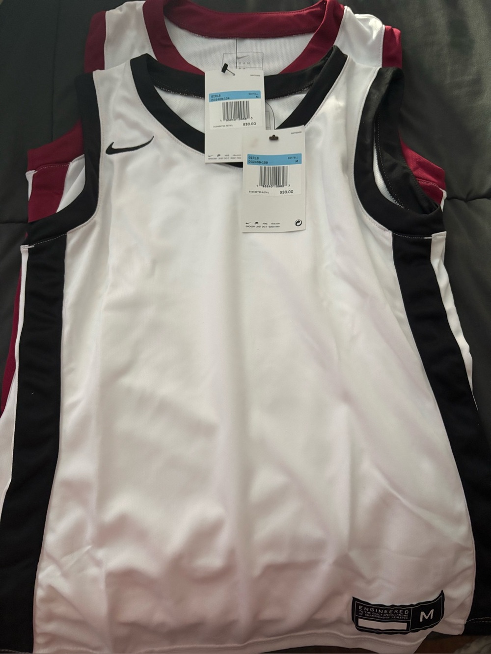 2 girls size medium Nike basketball jersey